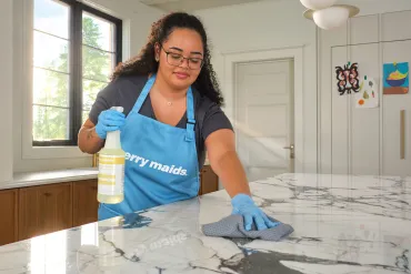 merry maid wiping down countertops